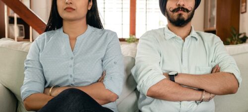 couple sitting with arm crossed